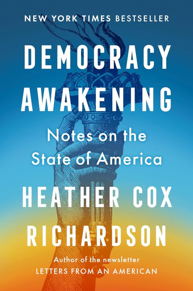 Front cover of Heather Cox Richardson's book, Democracy Awakening. The cover art is the torch of the Statue of Liberty over a bottom-top gradient of orange-blue.